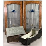 ANTIQUE WOODEN DOLL'S COT, beaten brass slipper box and a pair of leaded stained glass doors/panels,