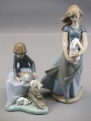 NAO FIGURINES (2) - a young girl holding a pet rabbit, 25cms H and a young child with three pet