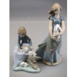 NAO FIGURINES (2) - a young girl holding a pet rabbit, 25cms H and a young child with three pet