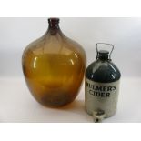 AMBER GLASS CARBOY and a stoneware flagon for Bulmer's Cider, 58 and 41cm heights respectively