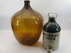 AMBER GLASS CARBOY and a stoneware flagon for Bulmer's Cider, 58 and 41cm heights respectively