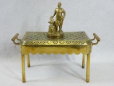 VINTAGE CAR MASCOT and a brass trivet stand having a pierced top and end carry handles, on tubular