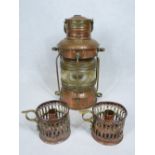 COPPER SHIP'S LAMP marked 'Anchor', 30cms H and a pair of pierced copper candleholders, stamped to