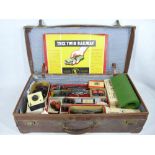 TRIX TWIN RAILWAY - boxed engines, track and trailer, ETC, all within an old leather suitcase