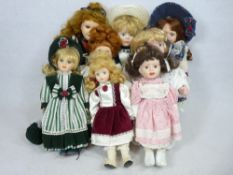 DOLLS - an assortment of various 20th century porcelain headed dolls with costumes