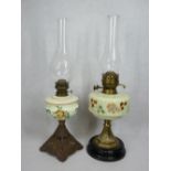 CIRCA 1900 OIL LAMPS, both with milk glass hand painted fonts with metal/pottery bases and clear