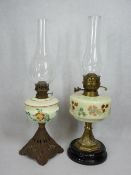 CIRCA 1900 OIL LAMPS, both with milk glass hand painted fonts with metal/pottery bases and clear