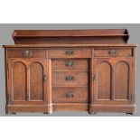 VICTORIAN MAHOGANY RAILBACK SIDEBOARD with a 'T' arrangement of six opening drawers and flanking