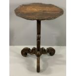 CARVED RUSTIC ANTIQUE OCCASIONAL TABLE on tripod supports with circular top, 76cms H, 60cms