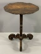CARVED RUSTIC ANTIQUE OCCASIONAL TABLE on tripod supports with circular top, 76cms H, 60cms