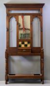 VICTORIAN HALLSTAND - having a central mirror and tiled section, a single drawer and drip trays,