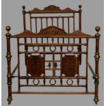 EARLY 20th CENTURY FRENCH 4ft 6ins BEDSTEAD in turned and carved wood with brass embellishments,