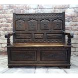 ANTIQUE JOINED OAK BOX SETTLE, panelled back and front profusely carved with foliage, lift up