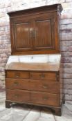 MID-18TH CENTURY OAK BUREAU CABINET, with narrow cavetto cornice and plain frieze above fielded