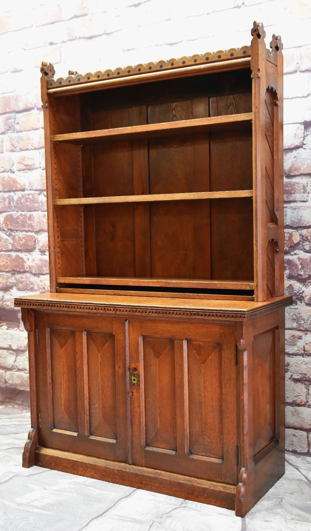 VICTORIAN GOTHIC REVIVAL OAK BOOKCASE ON A BASE, ebony dot-inlaid arcaded top with trefoil finals, - Image 2 of 4