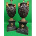 PAIR OF GILT METAL & BRONZE TWIN-HANDLED URNS of amphora shape in the Greek style with a band of