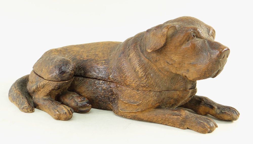 BLACK FOREST CARVED INKSTAND, in the form of a recumbent mastiff hound, hinged lid opening to reveal