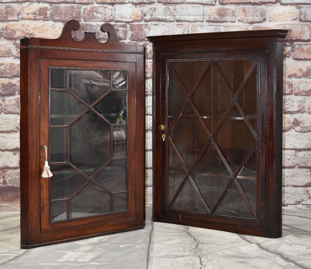 TWO EARLY 19TH CENTURY MAHOGANY HANGING CORNER CABINETS, both with glazed doors and shelves, one