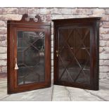 TWO EARLY 19TH CENTURY MAHOGANY HANGING CORNER CABINETS, both with glazed doors and shelves, one