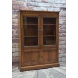 ERCOL ELM BOOKCASE, with glazed cupboard above panelled doors, 137.5h x 101w x 29cms