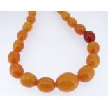 STRING OF GRADUATED OVAL BUTTERSCOTCH BEADS, 88cms long approx, 75gms approx