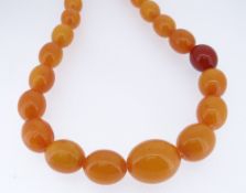 STRING OF GRADUATED OVAL BUTTERSCOTCH BEADS, 88cms long approx, 75gms approx