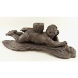 BURMESE CARVED WOOD ARCHITECTURAL FITTING carved as a figure recumbent on a winged deity or Nat,