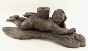 BURMESE CARVED WOOD ARCHITECTURAL FITTING carved as a figure recumbent on a winged deity or Nat,