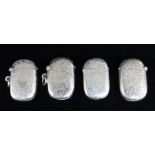 FOUR SIMILAR SILVER VESTA CASES, all engraved with scroll and foliate designs, two with engraved