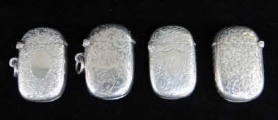 FOUR SIMILAR SILVER VESTA CASES, all engraved with scroll and foliate designs, two with engraved