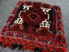 AFGHAN RUG CUSHION, red, cream, blue, orange and brown geometric decoration, fringe to one side,