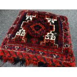 AFGHAN RUG CUSHION, red, cream, blue, orange and brown geometric decoration, fringe to one side,