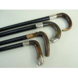 FOUR VINTAGE WALKING STICKS, all with ram's horn handles, one with gold plated copper collar,