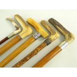 FOUR VINTAGE WALKING STICKS & A RIDING CROP, including crutch-handled stick with silver collar