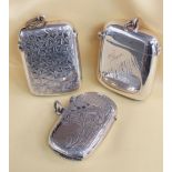 THREE SIMILAR SILVER VESTA CASES, of rectangular shape, all engraved, Birmingham and Chester