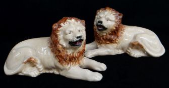PAIR OF STAFFORDSHIRE POTTERY FIGURES OF RECUMBENT LIONS, 20.5cms long Comments: crazing, one with