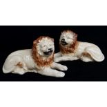 PAIR OF STAFFORDSHIRE POTTERY FIGURES OF RECUMBENT LIONS, 20.5cms long Comments: crazing, one with