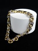 18CT GOLD TWO-TONE BRACELET of link design, 18.5cms long, 13.1gms