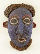 CAMEROONS GRASSLANDS BEADED MASK, with woven fibre beard of coiffure, 35cms high