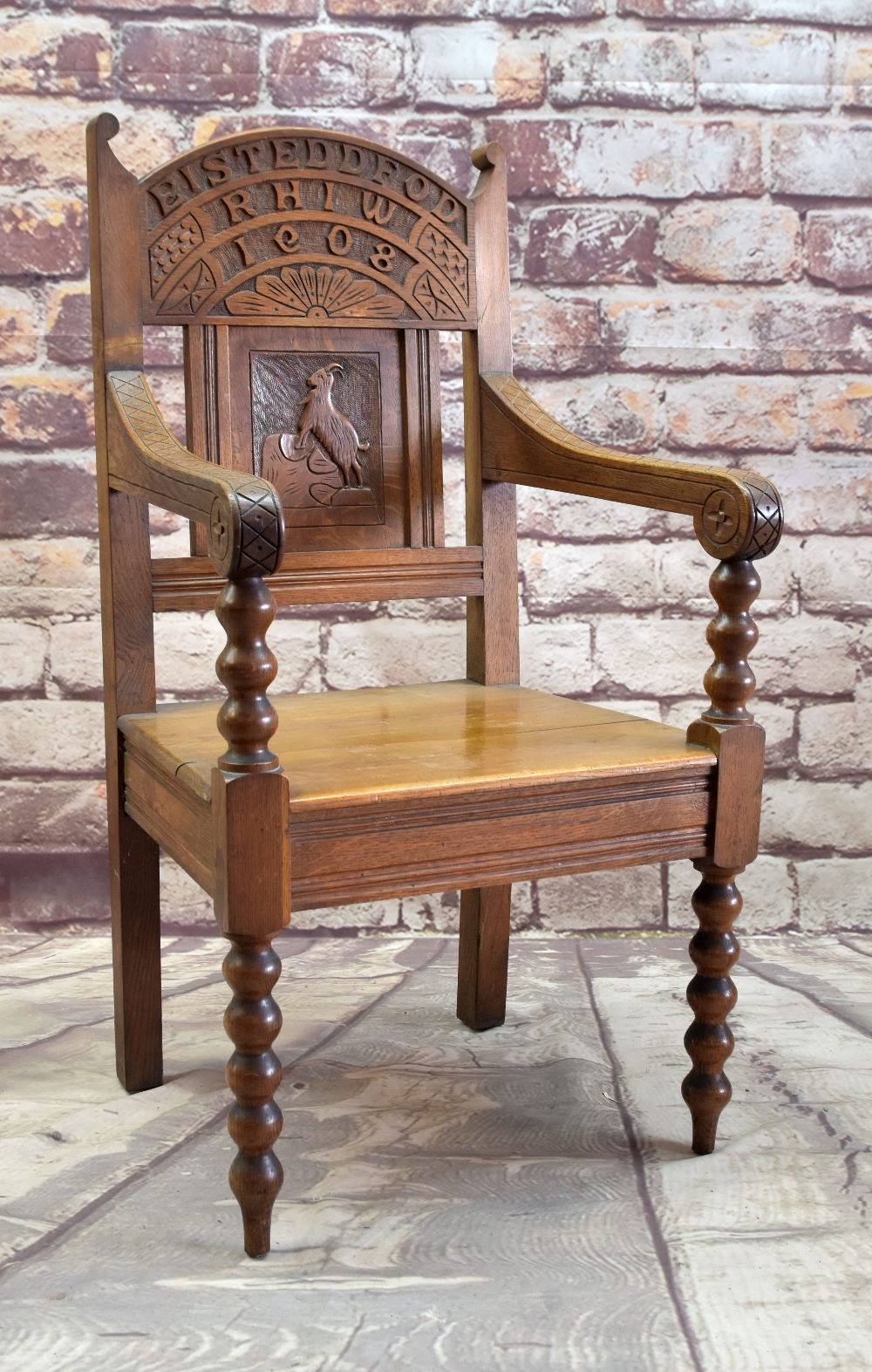 EISTEDDFOD CHAIR 1908 with carved panel of mountain goat, inscribed Eisteddfod Rhiw 1908 (with