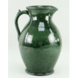 EWENNY POTTERY LARGE JUG in mottled deep green glaze, handle with spur, base inscribed Claypits