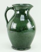 EWENNY POTTERY LARGE JUG in mottled deep green glaze, handle with spur, base inscribed Claypits