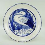 LLANELLY POTTERY PLATE with crimped rim, painted with a standing heron or stork amongst reeds,