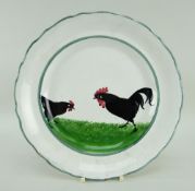 A LLANELLY POTTERY COCK & HEN DECORATED PLATE the birds pecking on grass and within green continuous