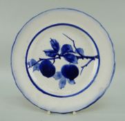 LLANELLY POTTERY PLATE painted in underglaze blue with a fruiting branch, within blue line border,