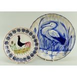 A LLANELLY POTTERY PLATE PAINTED IN BLUE WITH STORK IN REEDS of lobed form, 25cms diam, together