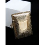 EDWARD VII 9CT GOLD VESTA CASE, of slightly curved rectangular form, scroll engraved with vacant