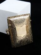 EDWARD VII 9CT GOLD VESTA CASE, of slightly curved rectangular form, scroll engraved with vacant