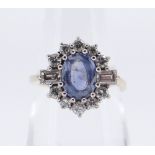 18CT GOLD SAPPHIRE & DIAMOND CLUSTER RING, the central oval sapphire 8 x 6 mm surrounded by ten