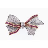 18CT WHITE GOLD DIAMOND & RUBY BAR BROOCH, of bow design with border of rubies, 4.2cms wide, 11.